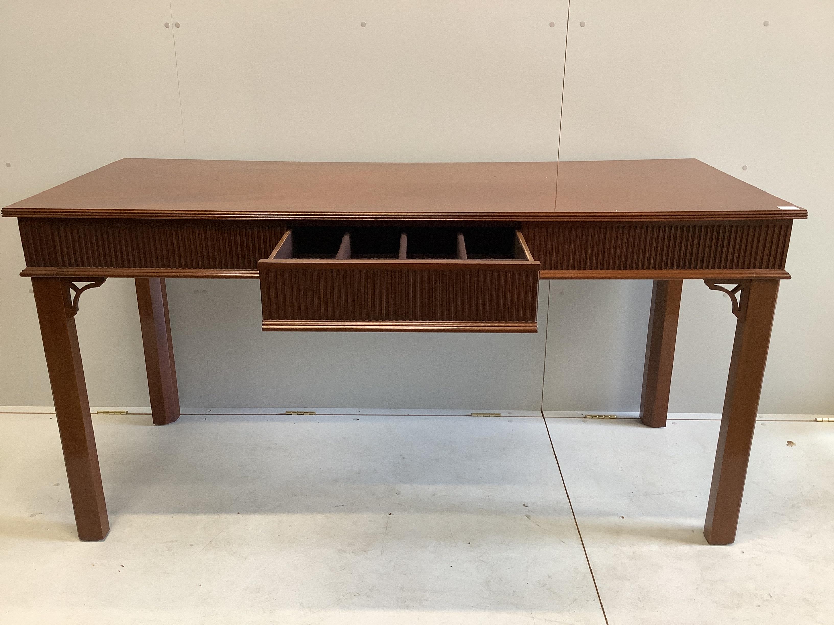 A George III style mahogany serving table, fitted three frieze drawers, the back incorporating two secret drawers, width 183cm, depth 76cm, height 92cm